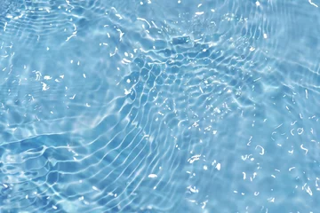 Gordijnen Blue water with ripples on the surface. Defocus blurred transparent blue colored clear calm water surface texture with splashes and bubbles. Water waves with shining pattern texture background. © Water 💧 Shining 📸