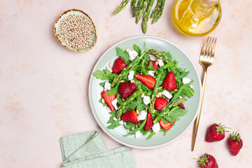 Salad with strawberries, asparagus, arugula, white cheese and nuts. Healthy eating. Vegetarian food.