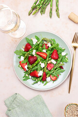 Salad with strawberries, asparagus, arugula, white cheese and nuts. Healthy eating. Vegetarian food.