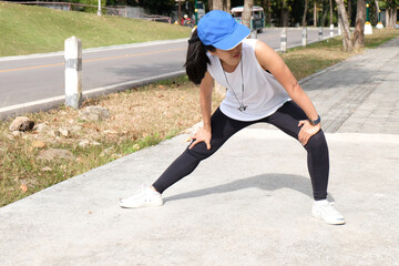 Young sporty woman workout before fitness training warming up in outdoors.