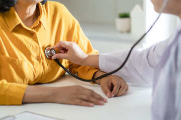 Doctor using a stethoscope checking patient stethoscope putting beat heart diagnose medical...