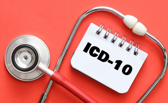 Concept of ICD-10 in a notebook on a red table next to a stethoscope. International Classification of Diseases and Related Health Problem 10th Revision or ICD-10.