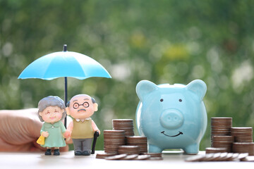 Mutual fund,Love couple senior with stack of coins money and piggy bank on green background, Save money for prepare in future and pension retirement concept