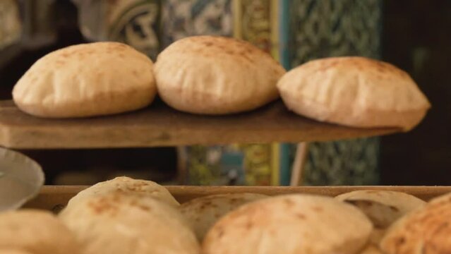 Freshly Baked Bread Being Taken Out Of Traditional Oven on Wooden Paddle and Served in Bakery