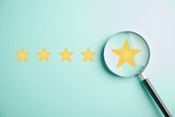 Magnifier glass used to focus on five stars icon for customer rating service. Satisfaction...