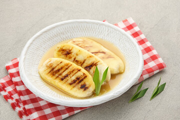Pisang Gapit or Pisang Epe, grilled banana with palm sugar sauce. Indonesian traditional food.
