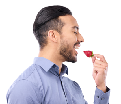 Healthy, diet and a man eating a strawberry isolated on a transparent png background for natural nutrition. Food, fruit and vegan with a person biting a red berry for dessert, wellness and vitamin c.