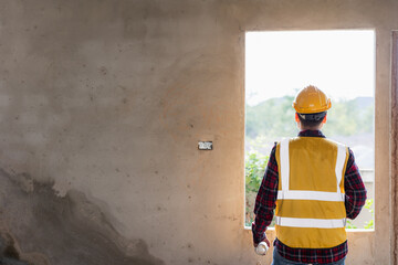 Fototapeta premium Male civil engineer in safety clothes using digital tablet to inspect work and quality control for construction contractor and real estate developer