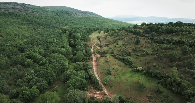 Aerial view of sierra de la demanda, Spain. Dron film green hill, trees and crop.