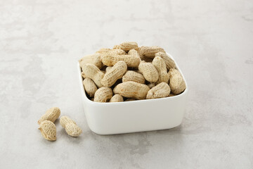 Roasted peanuts on small bowl. Copy space
