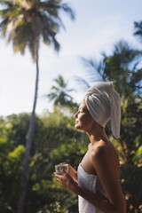 Good Morning of Woman With a Cup of Tea After Shower on Terrace Among Palm Trees