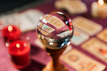 Fortune teller crystal ball on tarot table
