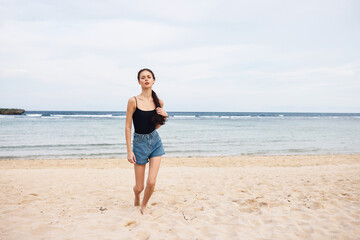 Fototapeta na wymiar beach woman lifestyle sea tan sunset young travel running summer smile