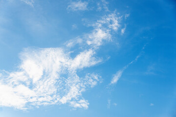 Scattered cloud clusters in a blue sky, blue sky background with white clouds.