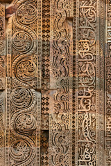 Wall decorative patterns of Qutb complex in South Delhi, India, close up ancient bas relief