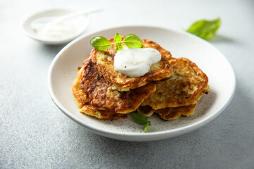 Traditional homemade latkes with sour cream