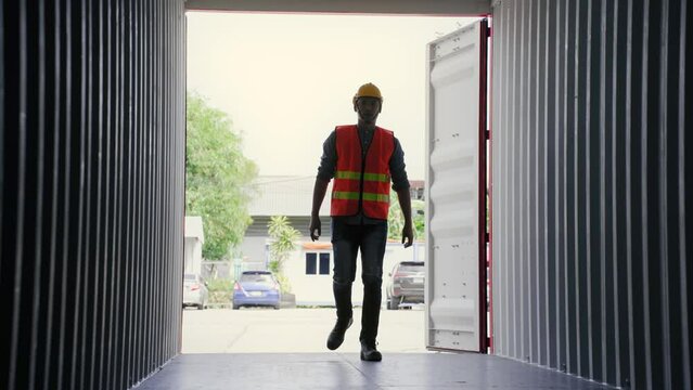 Asian foreman open container box and walk in side to check neatness prepare in terminal logistic warehouse. Cargo shipping and Transport concept
