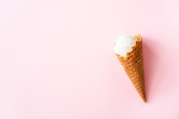 Ice cream cone top view on pink. Minimal composition.