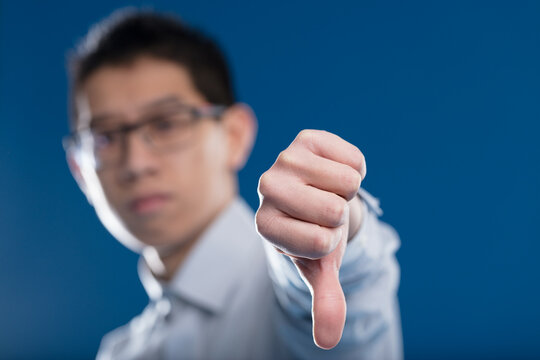 Asian man, blurred, shows disagreement