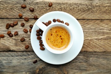Cup of freshly brewed coffee on a wooden background.