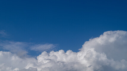 Naklejka na ściany i meble Blue clouds in the sky. White fluffy clouds. Clouds close-up