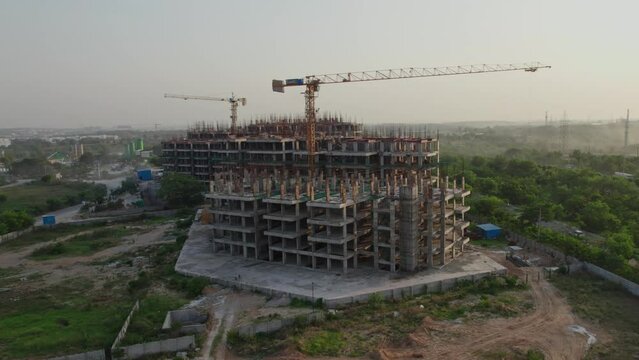 big construction building near express highway during sunset areal orbit drone shot 4k 30p