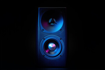 Multimedia acoustic sound speaker with neon lighting. Sound audio system on dark background.