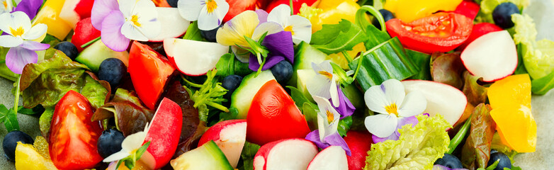 Tasty summer salad with edible flowers