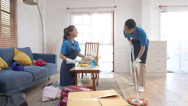 The house cleaning service team cleans the living room at the customer's house.