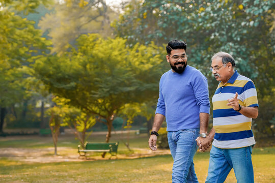 Old Indian Father With His Young Son Spending Time At Park.
