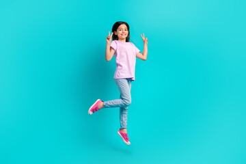 Full size body of schoolgirl pink t-shirt with jeans show double v-sign greetings symbol jumping isolated on aquamarine color background