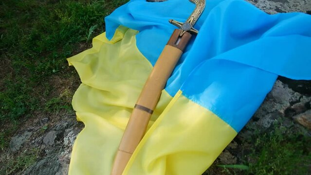 The saber of the Ukrainian Cossacks lies on the flag of Ukraine.