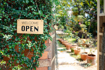 Open sign hanging in front of cafe