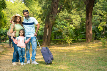 Fototapeta premium Indian family with suitcase bags. ready for going to holidays trip.