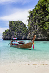 Traditional longtail boat with beautiful scenery view at Maya Bay on Phi Phi Leh Island in sunshine day.