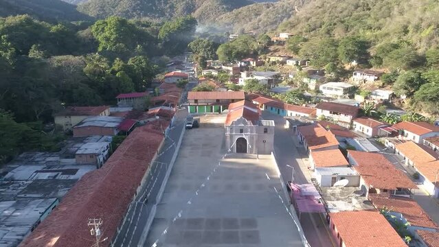 Aerial Shot backward over tropical coastal village, scene Chuao downtown Venezuela
