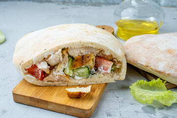 Kebab of chicken and vegetables served in a pit with sauce, shawarma, shawarma with chicken in a pit.