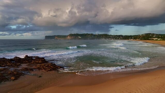Sunrise seascape with clouds and waves at North Avoca on the Central Coast, NSW, Australia.