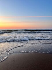 Fototapeta premium Orange sea coast, twilights at the sea, sandy coastline, natural evening seascape background