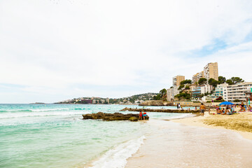 City beach on Palma de Mallorca. Sea, people, hotels and residential buildings.