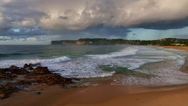 Sunrise seascape with clouds and waves at North Avoca on the Central Coast, NSW, Australia.