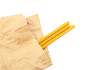 Parchment and church candles on white background, top view