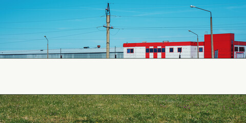Long white blank hoarding with mockup space for commercial info mounted outdoor on temporary fence at city street © Bonsales