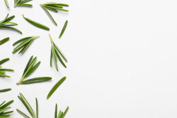Sprigs of fresh rosemary on white background, flat lay. Space for text