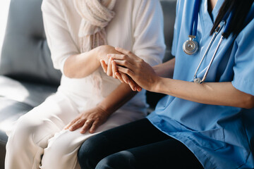 medical doctor holing patient's hands and comforting her.Kind doctor giving real support for patient...