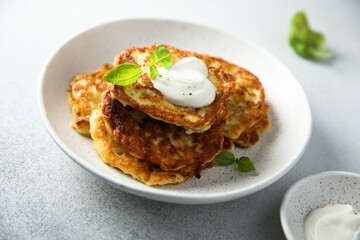 Traditional homemade latkes with sour cream
