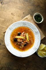 Traditional homemade soup with sausage and capers