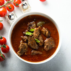 Homemade beef goulash with fresh basil