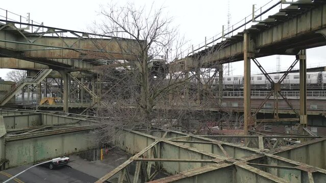 View of a Train Leaving a Rusty Elevated Subway Train Structure in Brooklyn - Pt. 1