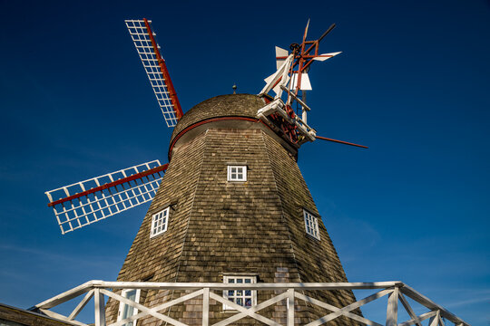 02-04-2023 Skanderborg, Denmark - Corn mil with white wooden railing, blue sky